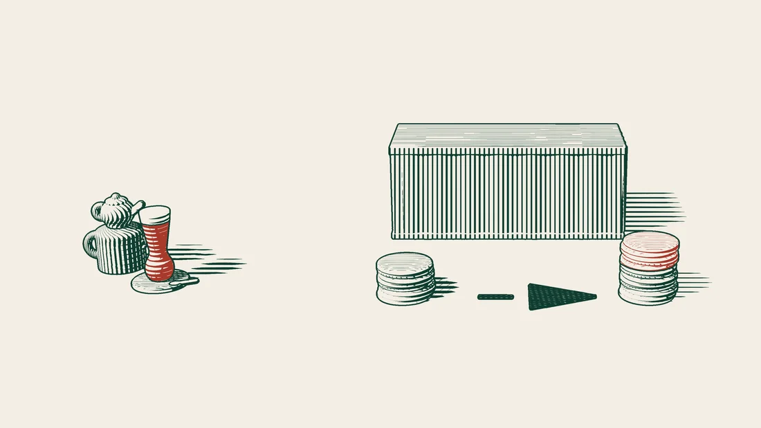 Two stacks of money in front of a shipping container, one plain and the other the same stack topped with red coins.