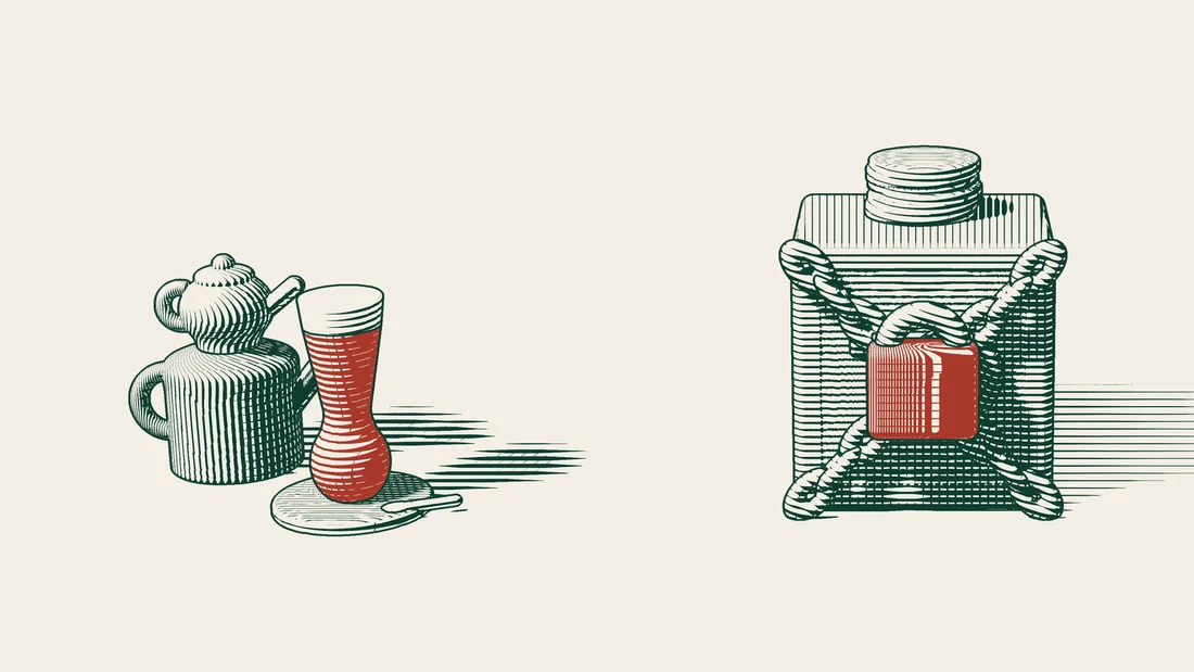 A safe topped with stacks of coins, wrapped in crossed chains and locked with a red padlock, next to a Turkish tea set.