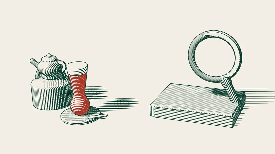 A magnifying glass rests on a thick closed law book, with a Turkish tea glass and teapot beside it.