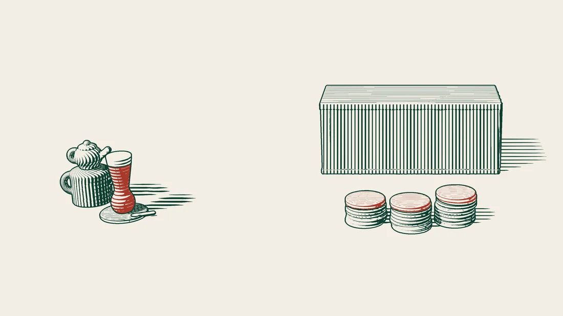 Three stacks of coins in front of a shipping container, each topped with a red portion of a different size.
