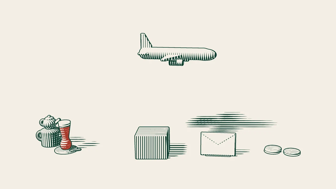 A small parcel and an envelope beneath an aeroplane, with a few coins lying beside them.