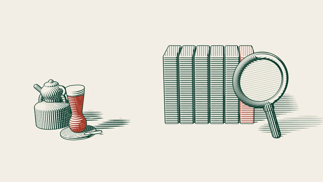A magnifying glass leans against a row of six binders, one of them red, with a Turkish tea set to the left.