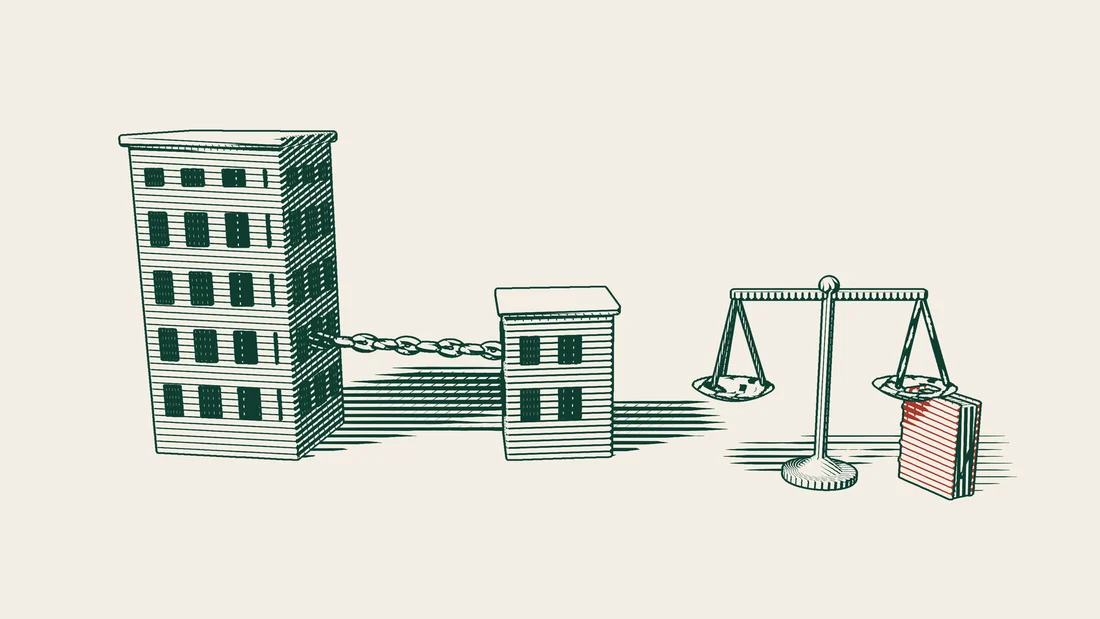 A tall company building and a small one next to it are joined by a thick chain, with a scale and a red bound book on the right.