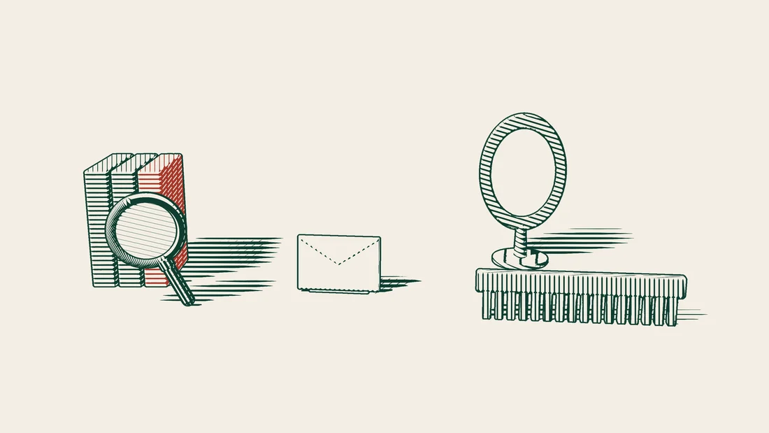 Three file folders, one bound in red, with a magnifying glass and a closed envelope, beside a standing mirror and a large long-toothed comb.