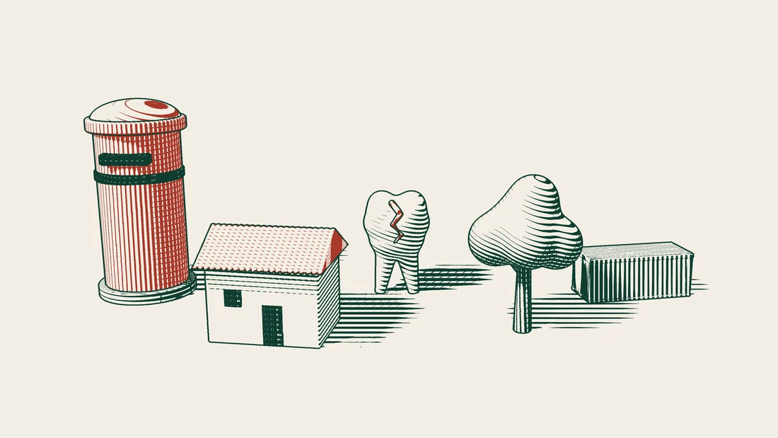 A tile-roofed house, a cracked tooth model, a tree and a shipping container are lined up in front of a red pillar box.