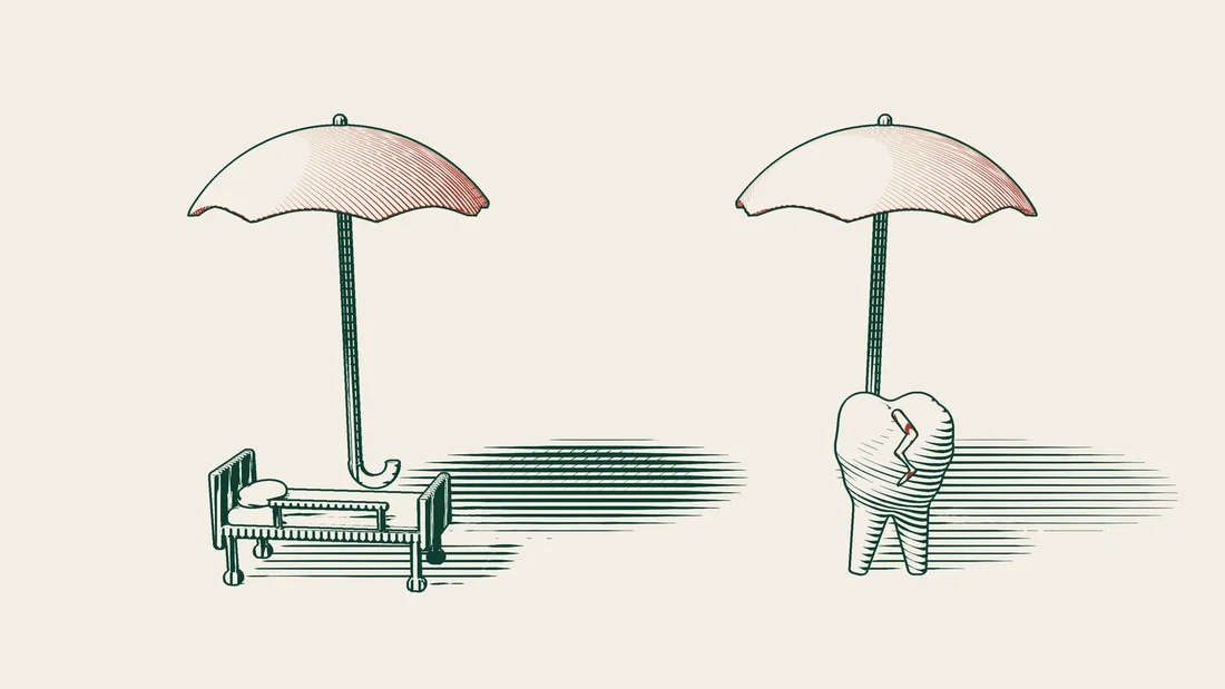 A hospital bed under a red umbrella on the left and a cracked tooth model under a second red umbrella on the right.