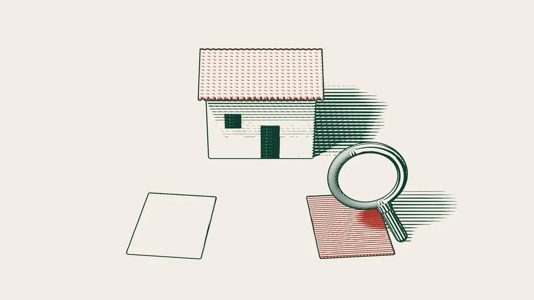 Two blank title deed papers lie side by side, one of them red, under a magnifying glass with a house behind.