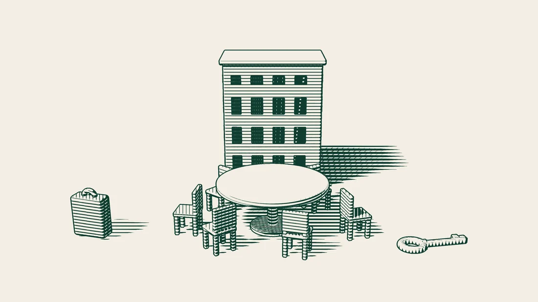 A round table with six chairs stands before an apartment building, with a single blank sheet of paper lying on it.