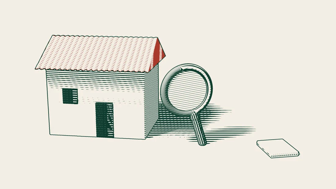 A magnifying glass examines the wall of a house, with report sheets that carry no writing laid out in front of it.