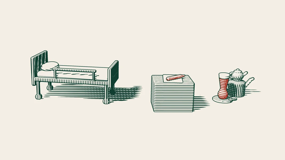 A blank sheet of paper and a fountain pen on a bedside table next to a hospital bed, with a Turkish tea set beside them.
