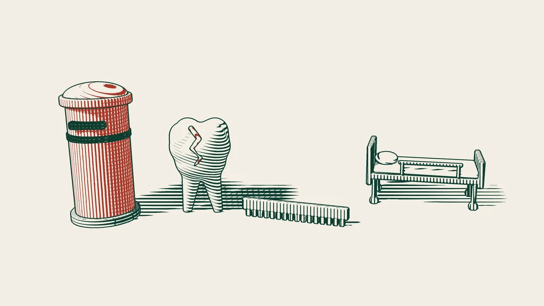 A red postbox followed in a row by a cracked tooth model, a comb and a hospital bed.