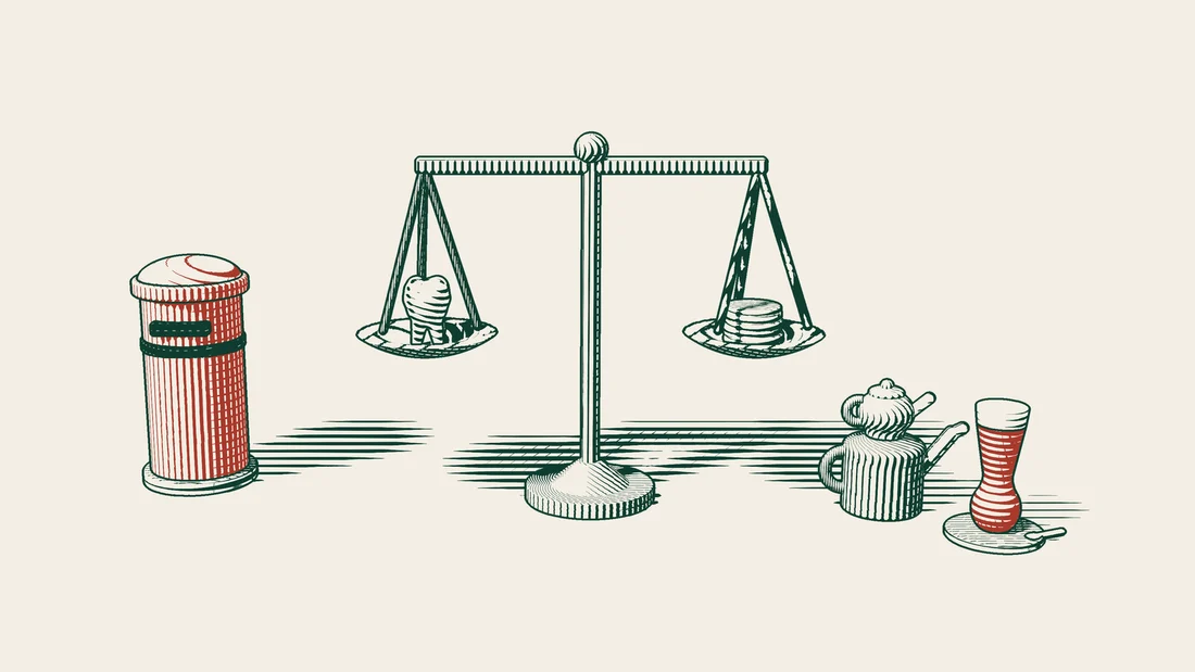 A balance with a dental model on one pan and a stack of coins on the other, a red British postbox standing beside it.