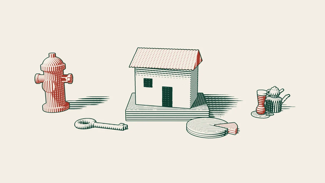 A tiled-roof house on a stone base with a brass key and a disc missing one slice, a red US fire hydrant far off and a Turkish tea set.