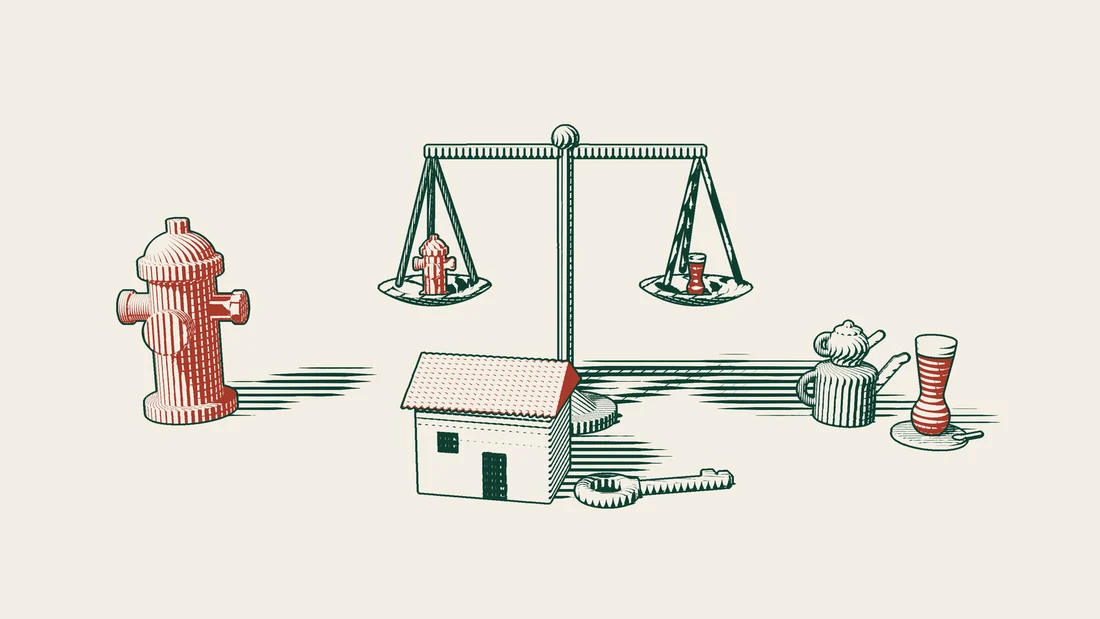 A balance with a small red fire hydrant on one pan and a Turkish tea glass on the other, a house and a key in front.