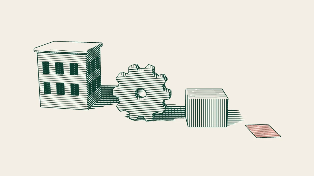 A service building with a cogwheel, a carton of spare parts and a red certificate standing in front of it.