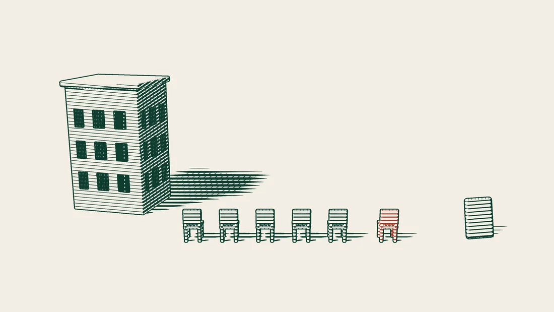 Five green chairs and one red chair stand in front of a company building, with a passport placed beside them.