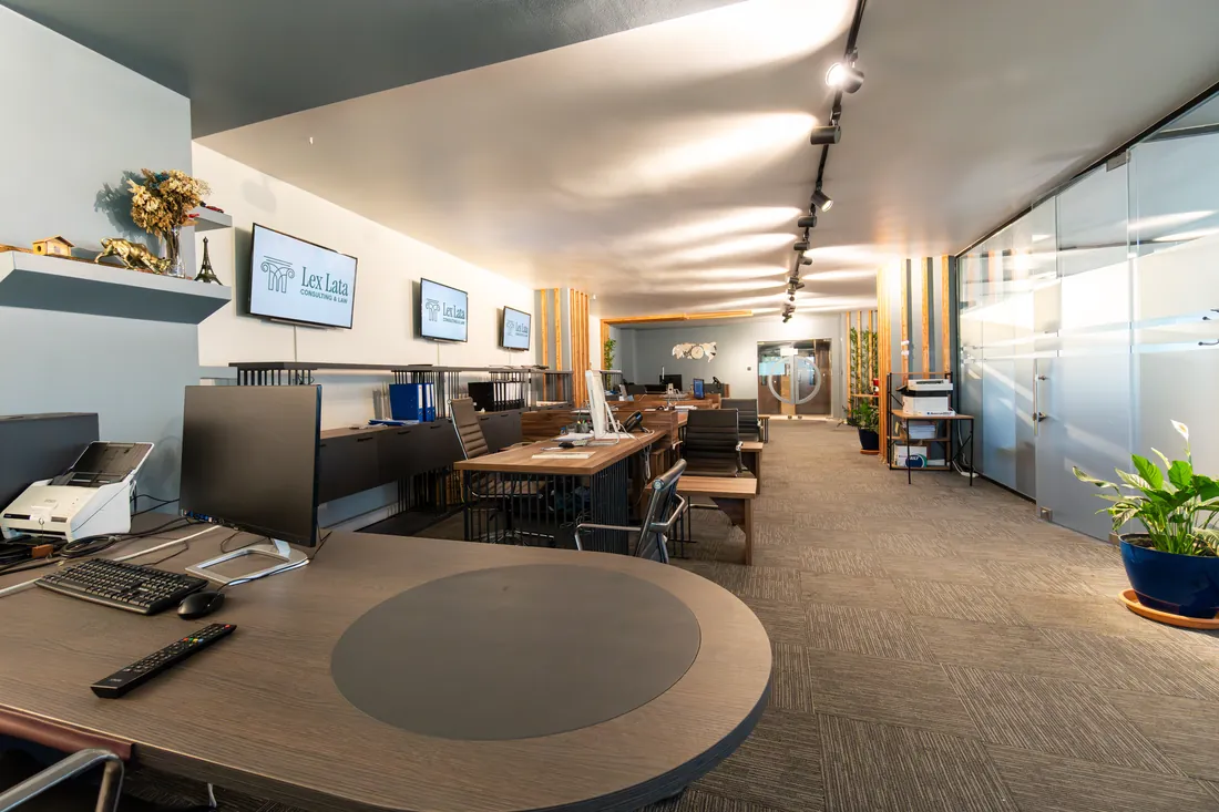 The Lex Lata office in Kağıthane, Istanbul: desks and wall screens showing the Lex Lata logo