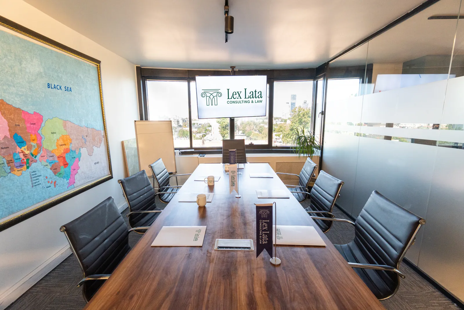 The Lex Lata meeting room: a long table, a map of Istanbul on the wall and a screen with the Lex Lata logo